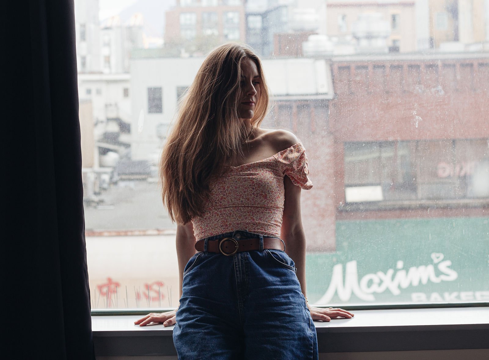 woman standing at big window