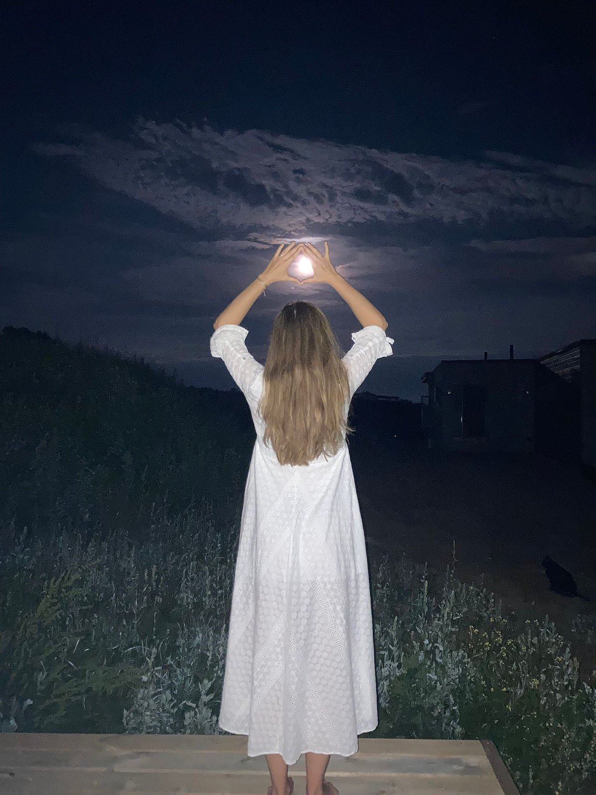 Woman embracing full moon
