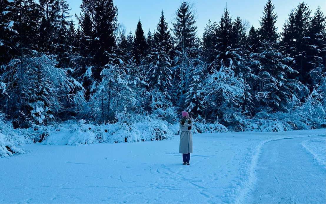 woman standing in snow and looking around
