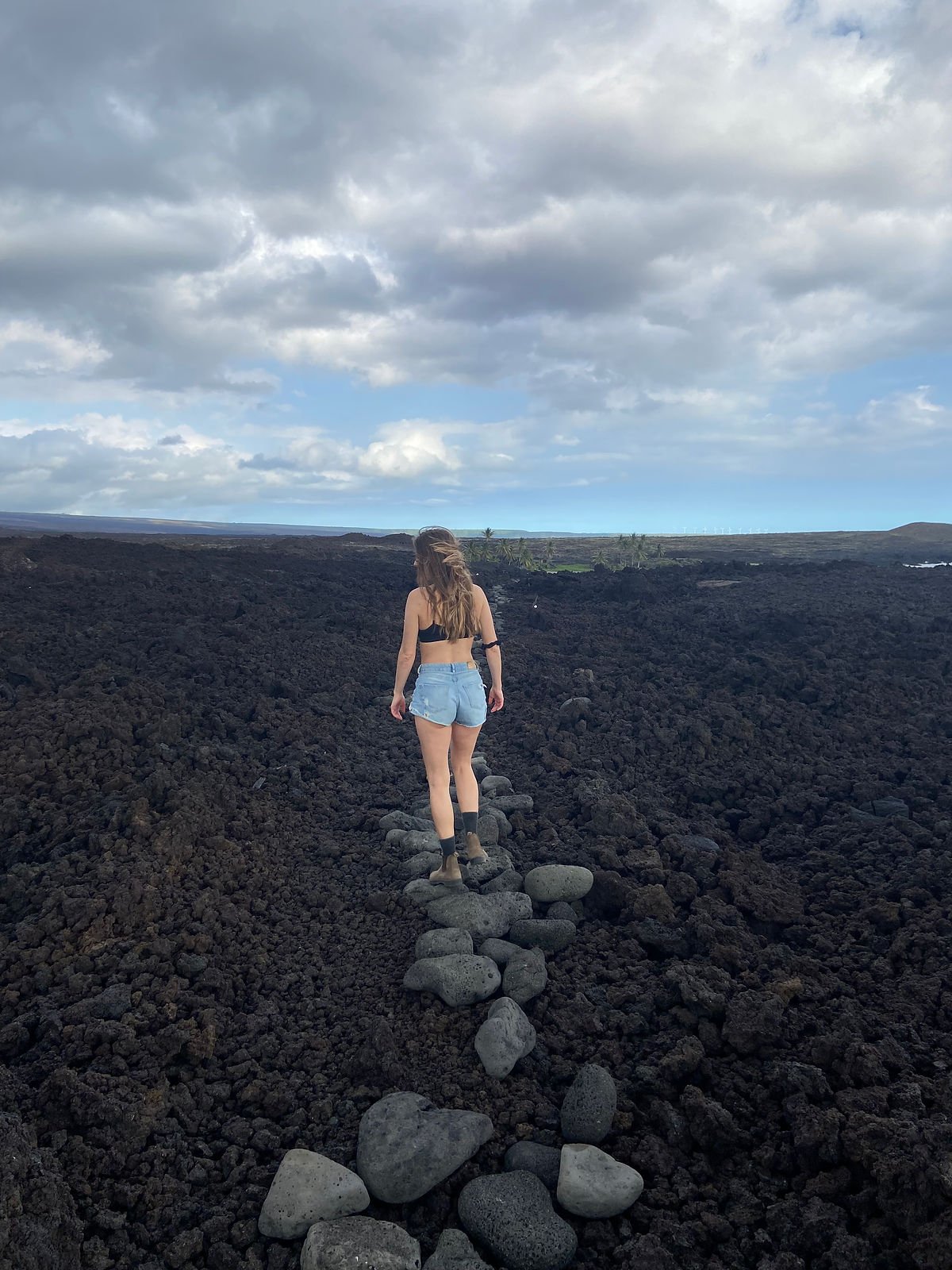 A woman walking on a lava field