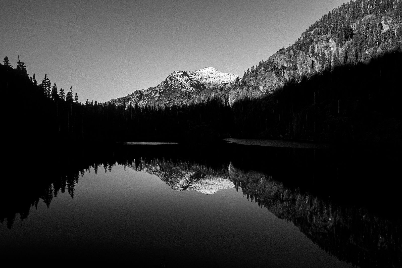 black and white picture of a mountain lake