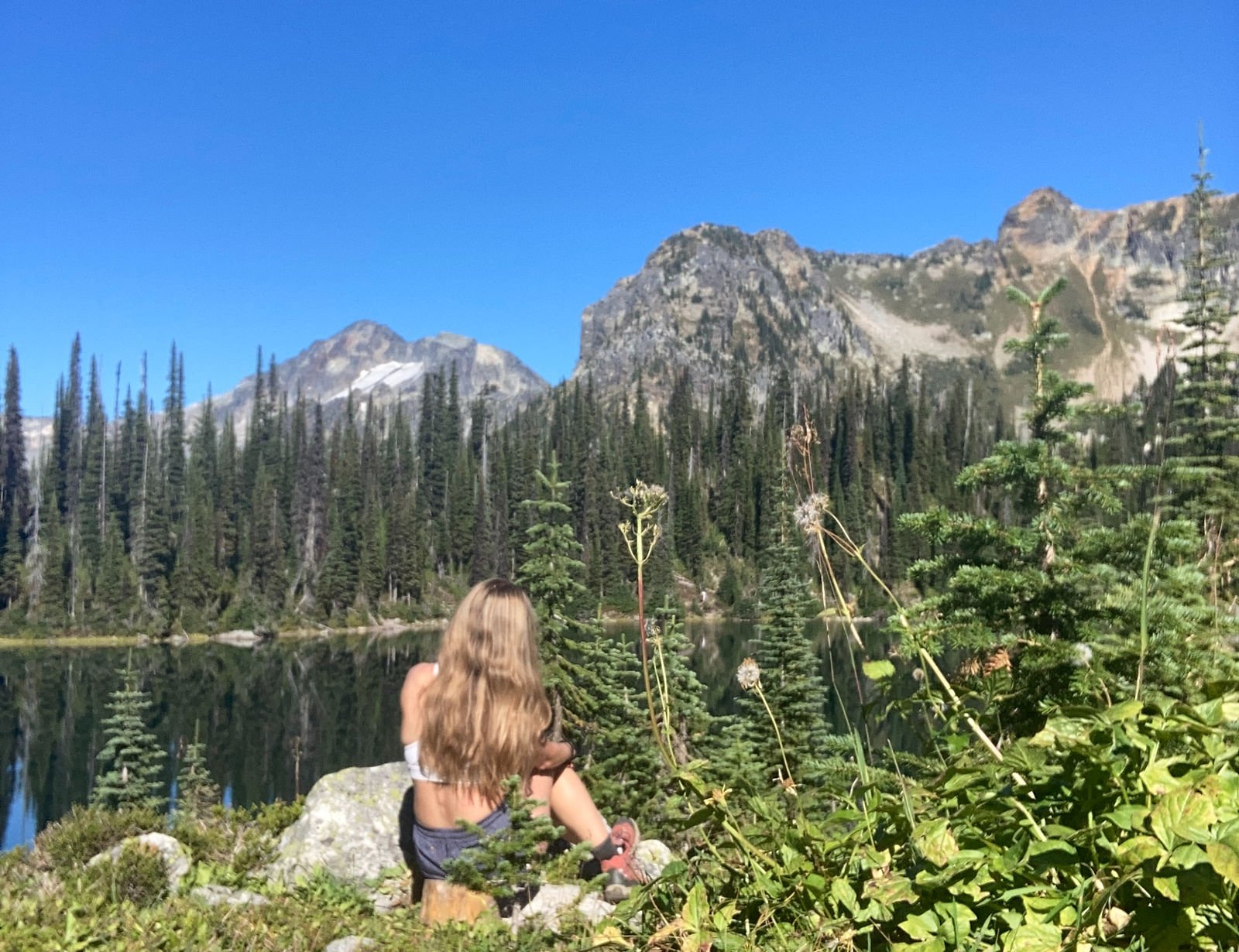 Girl sitting on a rock in the mountains