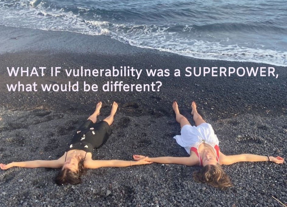 two girls lying on the black beach